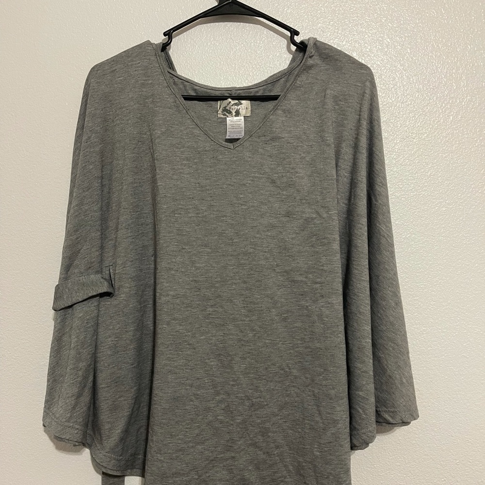 Grey poncho by the brand paraella. Size medium
